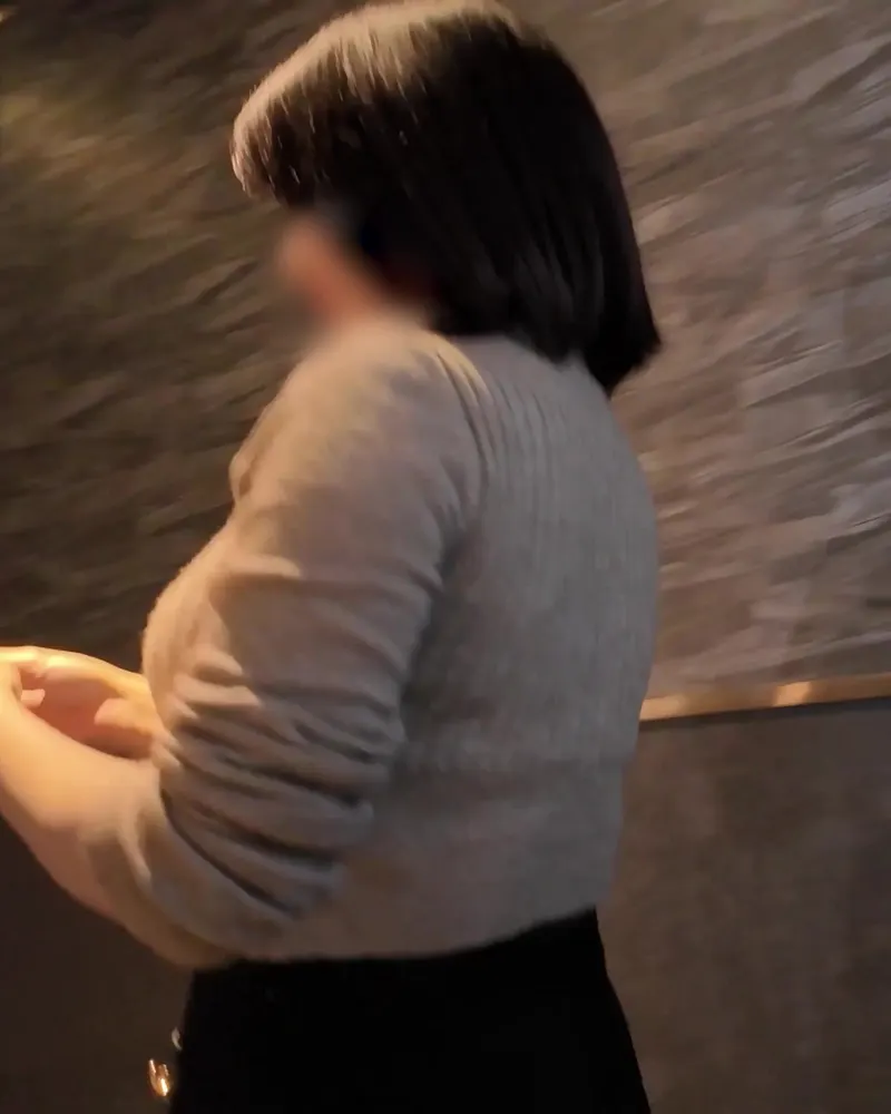 A performer in KEEP-OUT’s supplied promotional still wearing a knit top, with the source face blur preserved