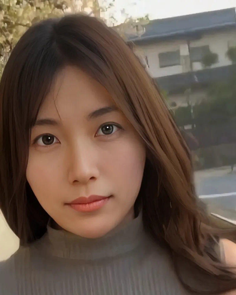 Mika outdoors in a grey knit top